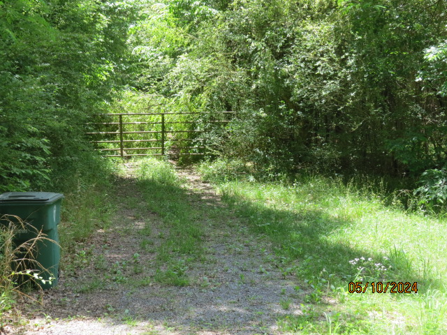 A gate to an abandoned house located off the property